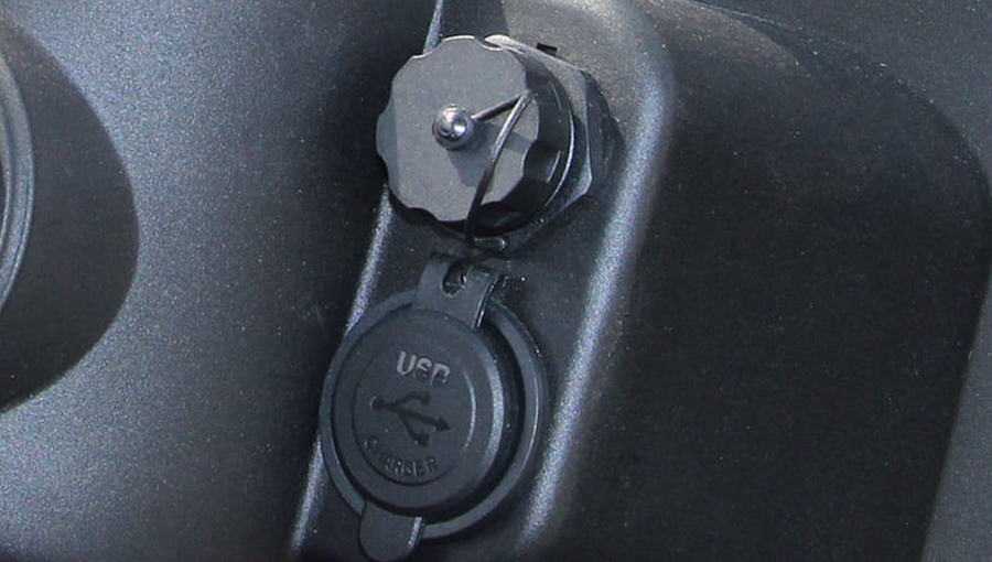 Close-up of USB charging port installed on Tara utility task vehicle dashboard, enabling easy device charging on the go