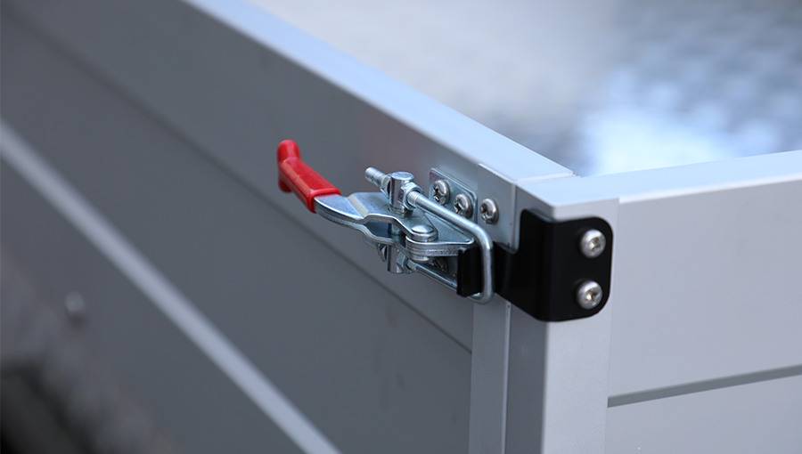 Heavy-duty toggle clamp securing the cargo box lid of Tara Turfman utility vehicle, ensuring safe transport