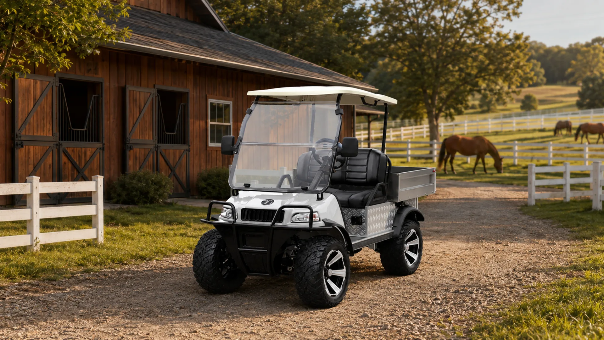White TARA utility task vehicle (UTV) at a horse barn with paddocks